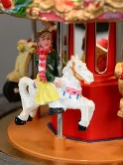 New Christmas Warehouse Kids Enjoying A Winter Fun Park Merry-Go-Round Christmas Village Scene - 23Cm