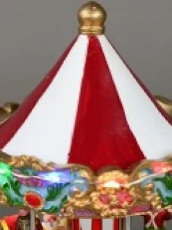New Christmas Warehouse Kids Enjoying A Winter Fun Park Merry-Go-Round Christmas Village Scene - 23Cm
